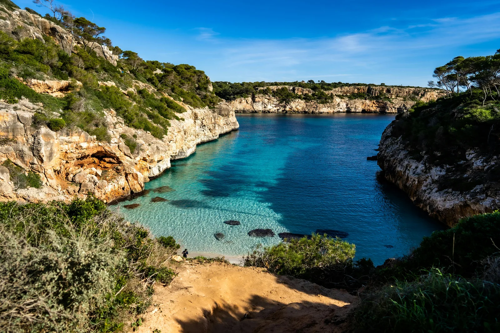 Aerial view of Cala d'Or–style coves at golden hour.
