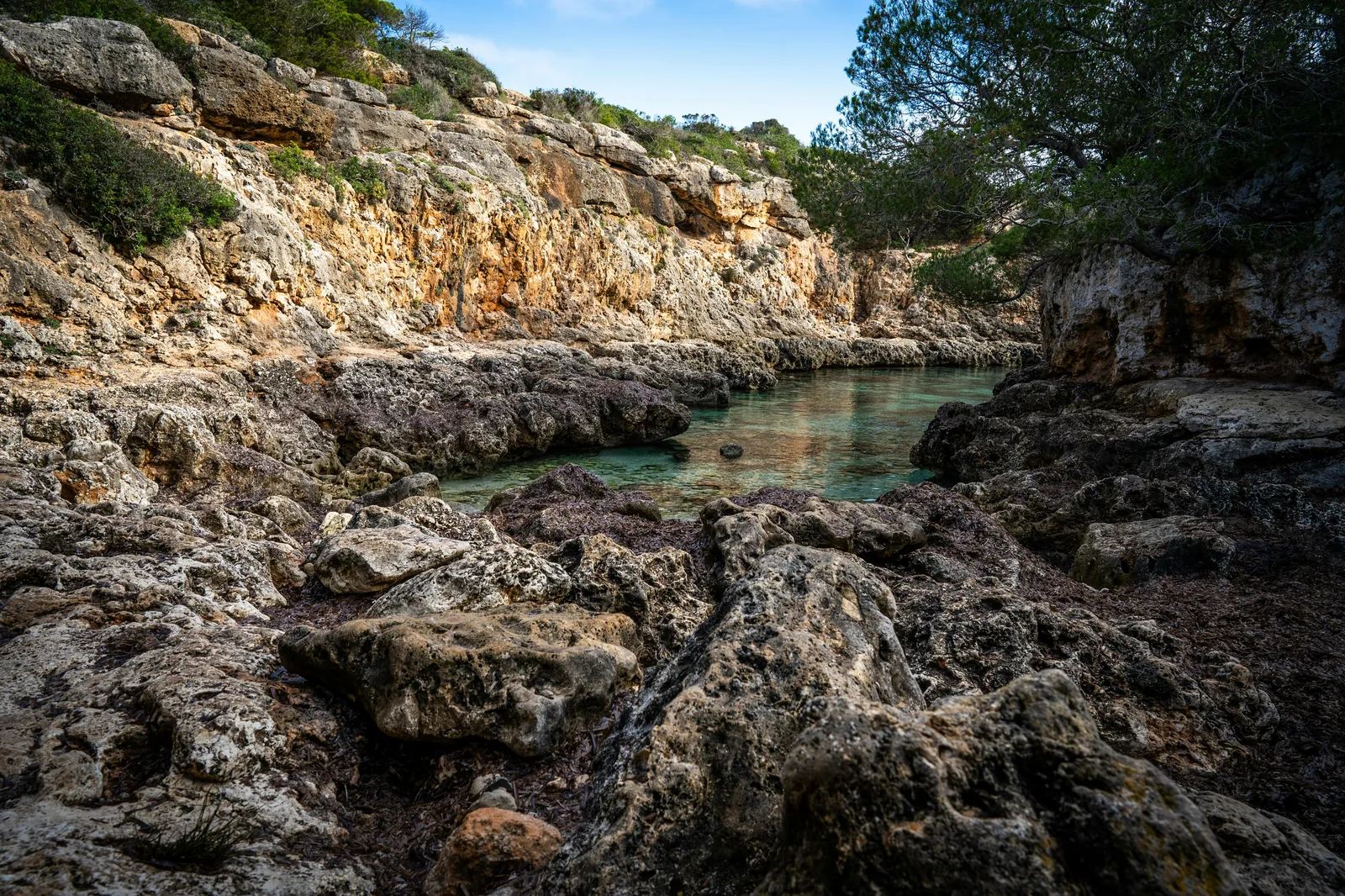 Aerial split-scene showing Mallorca's tranquil coves versus Ibiza's vibrant beach scene.