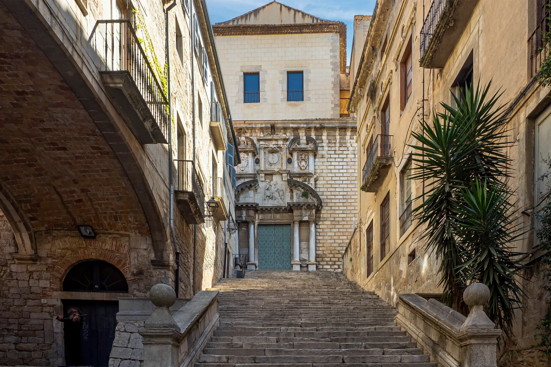 Charming stone staircase leading to the Church of Sant Martí Sacosta in Girona, Spain.