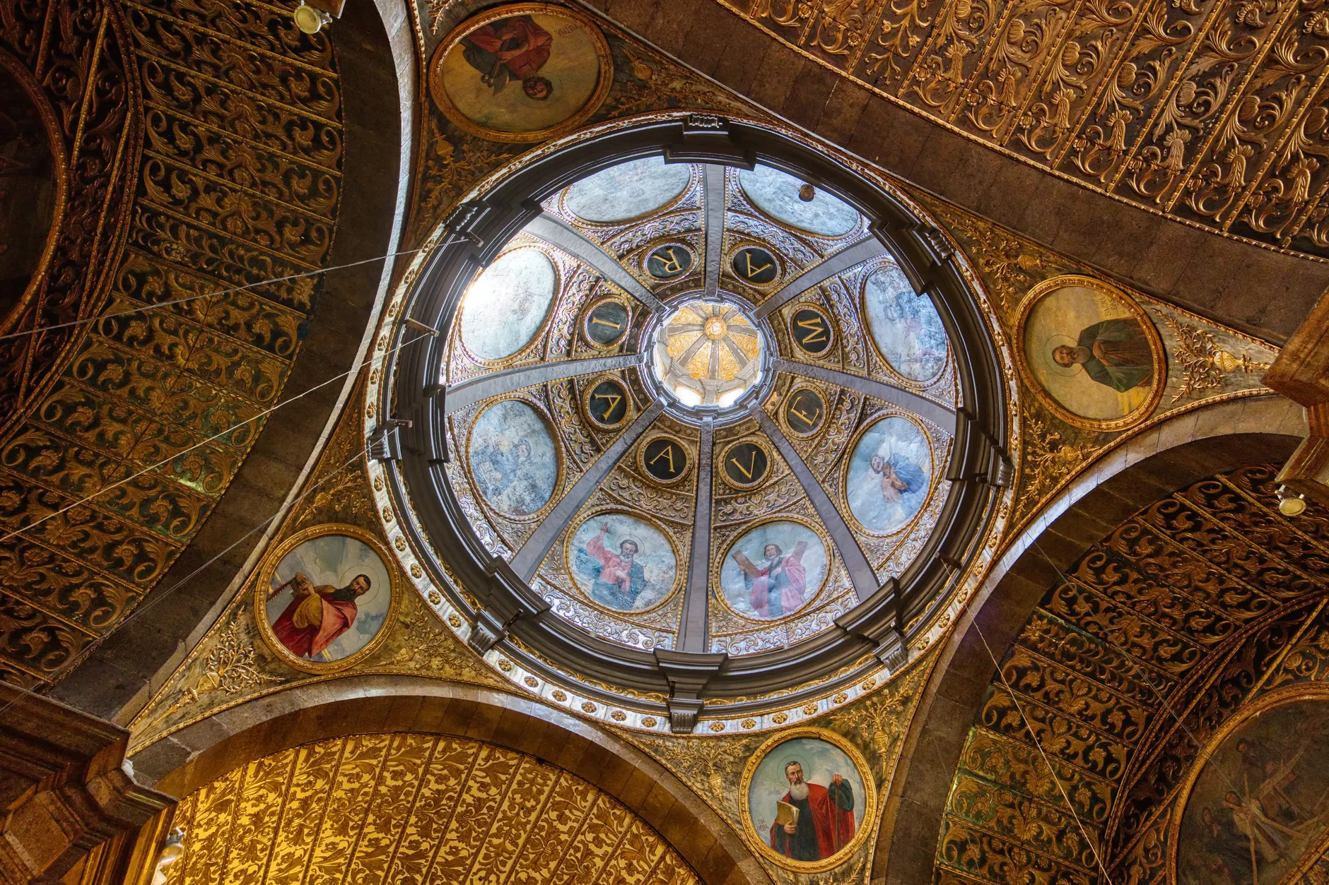 Intricately decorated church dome interior with religious paintings in Lluc, Spain.
