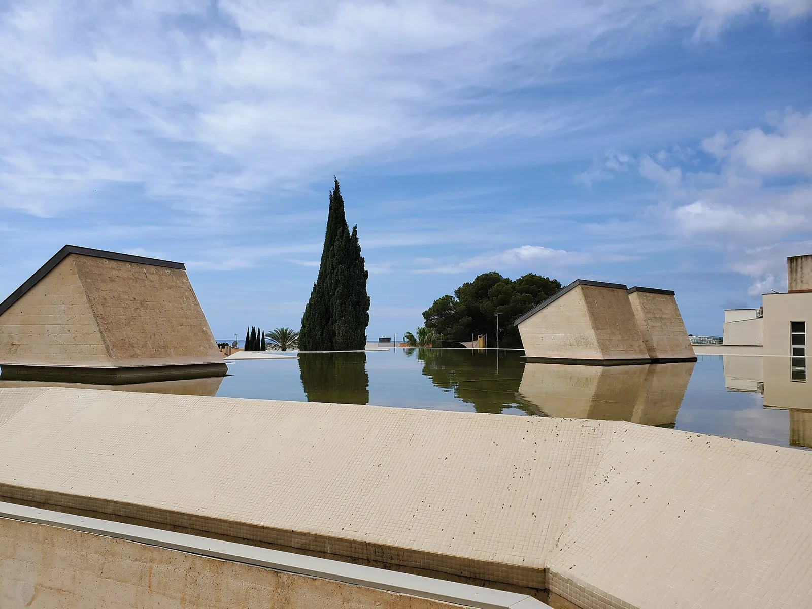 Bassin et volumes pyramidaux du bâtiment de la Fondation Miró à Palma sous un ciel bleu
